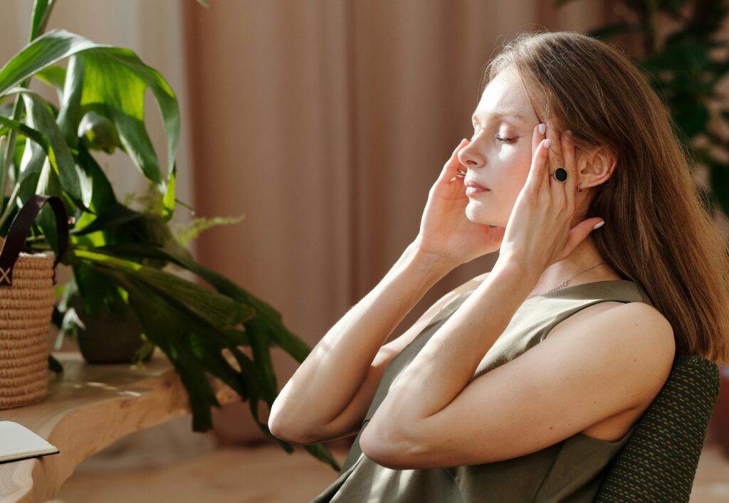 Person massaging temples while experiencing a headache 